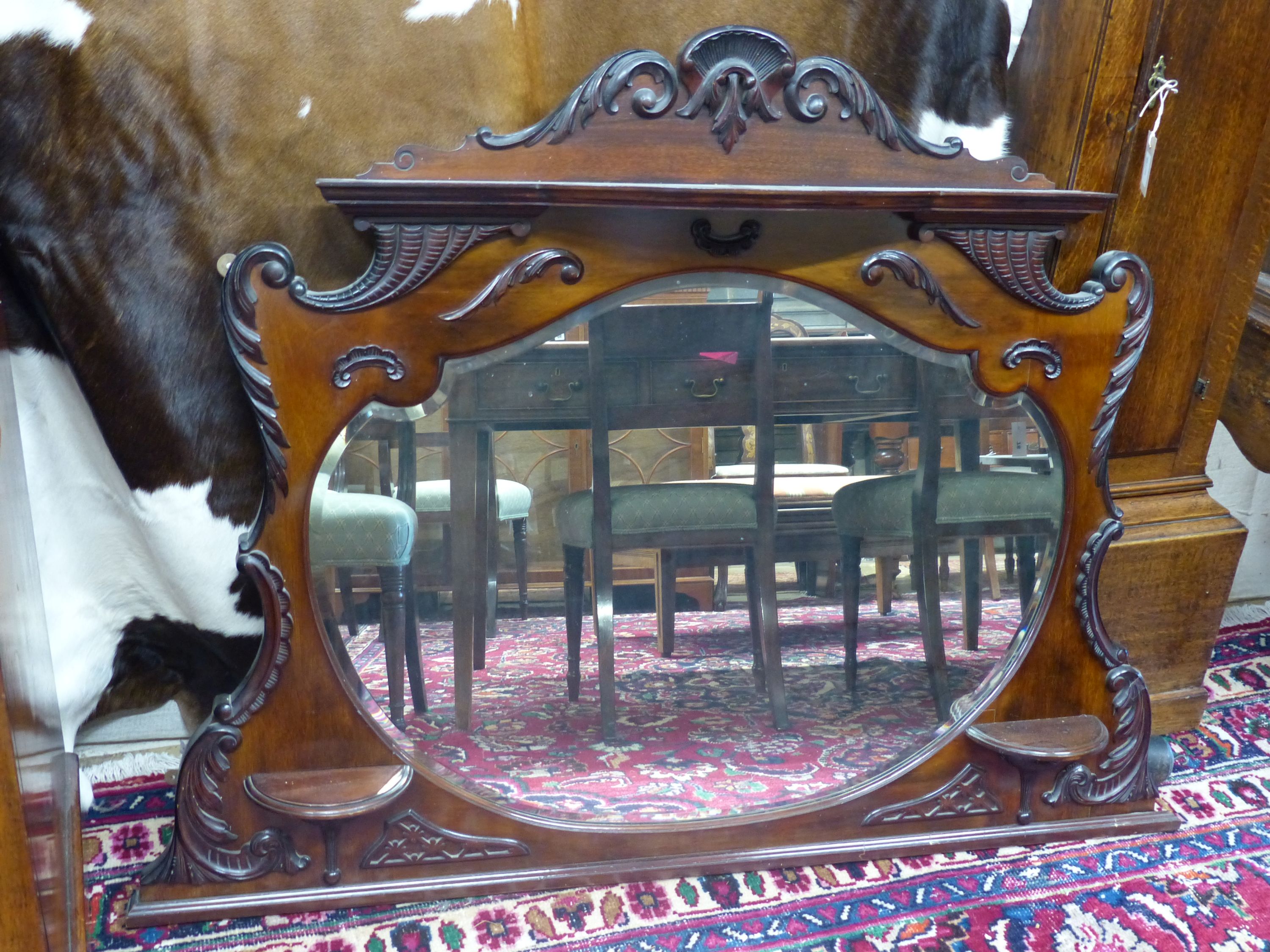 A late Victorian mahogany overmantel mirror, width 135cm, height 100cm